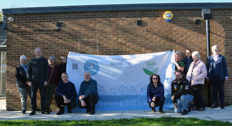 group photo of Hurst Farm partners grouped around a large banner with text celebrating the start of the project.