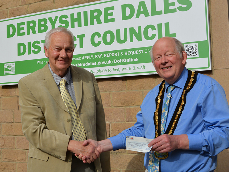 Peter Savidge presents the cheque for £1,000 to Civic Chair Councillor David Burton at the Town Hall, Matlock
