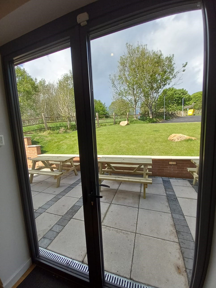 View through the back windows onto new terrace and car park