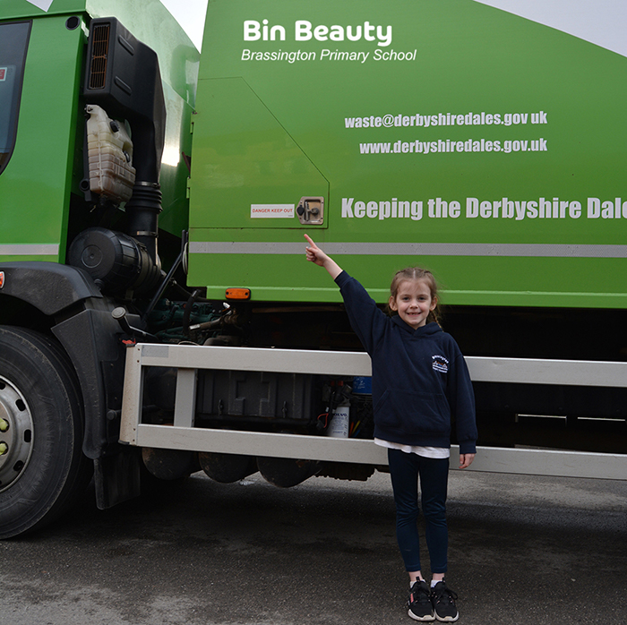 Jessie representing Brassington Primary, pointing to the Bin Beauty truck name