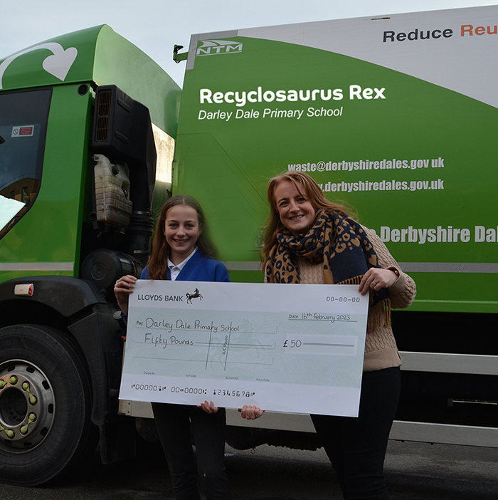 Annabelle and teacher representing Darley Dale Primary, pointing to the Recyclosaurus Rex truck name